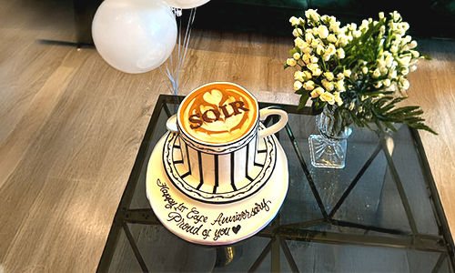 Customized women�fs cake designed with a coffee cup theme, personalized message, and elegant cake presentation.