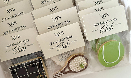 Custom tennis-themed sugar cookies and branded event logo.
