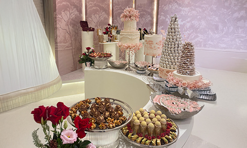 Catering buffet featuring cakes, chocolates, and assorted gourmet savory items